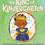 Book cover for The King of Kindergarten. A young Black boy is smiling and wearing a gold crown.