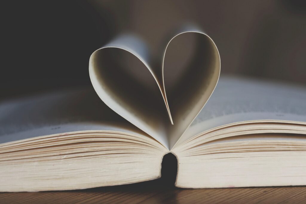 An open book whose pages form a heart shape