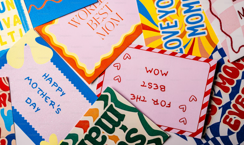 Multiple colorful celebration cards that read 