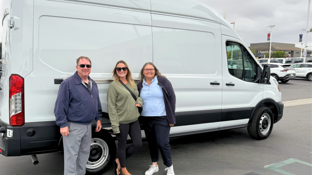 UTR staff members standing in front of a mobile story station