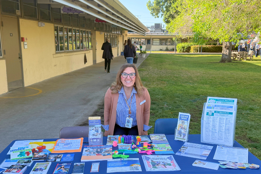photo of a UTR volunteer at a resource table