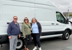 UTR staff members standing in front of a mobile story station